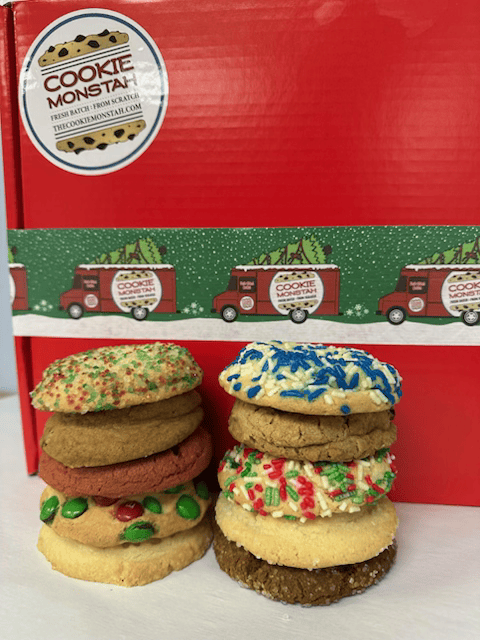 Stack of colorful cookies in front of a red box with 'Cookie Monsta' branding.